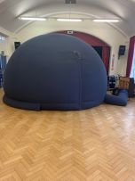 A material, inflatable, blue dome in a school hall
