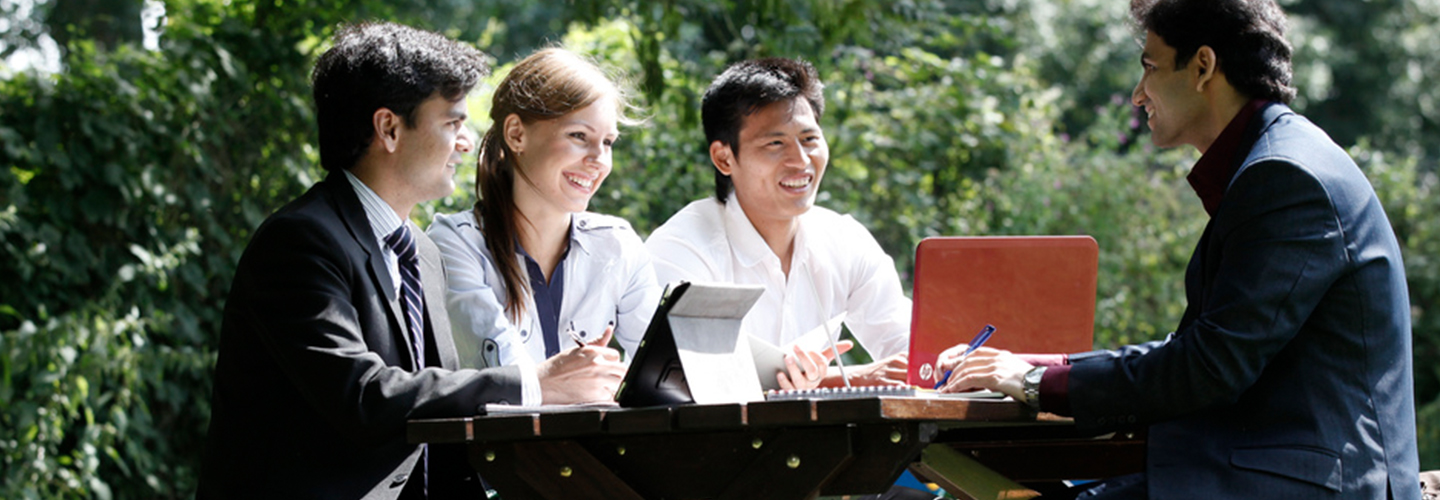 Female and male staff having meeting outside