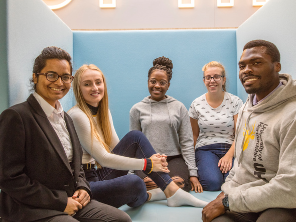 Group of female and male students in circle