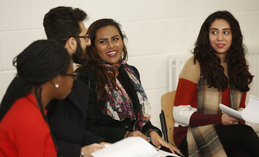 students discussing and reading papers