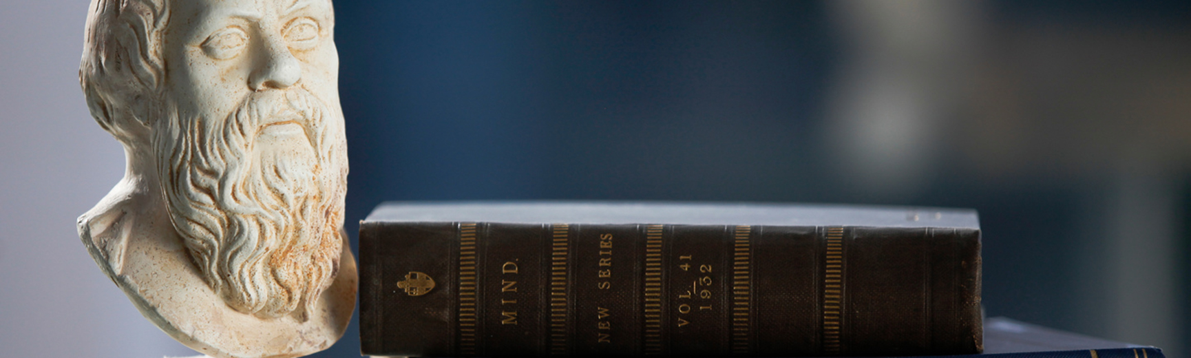 a statue adjacent to a book