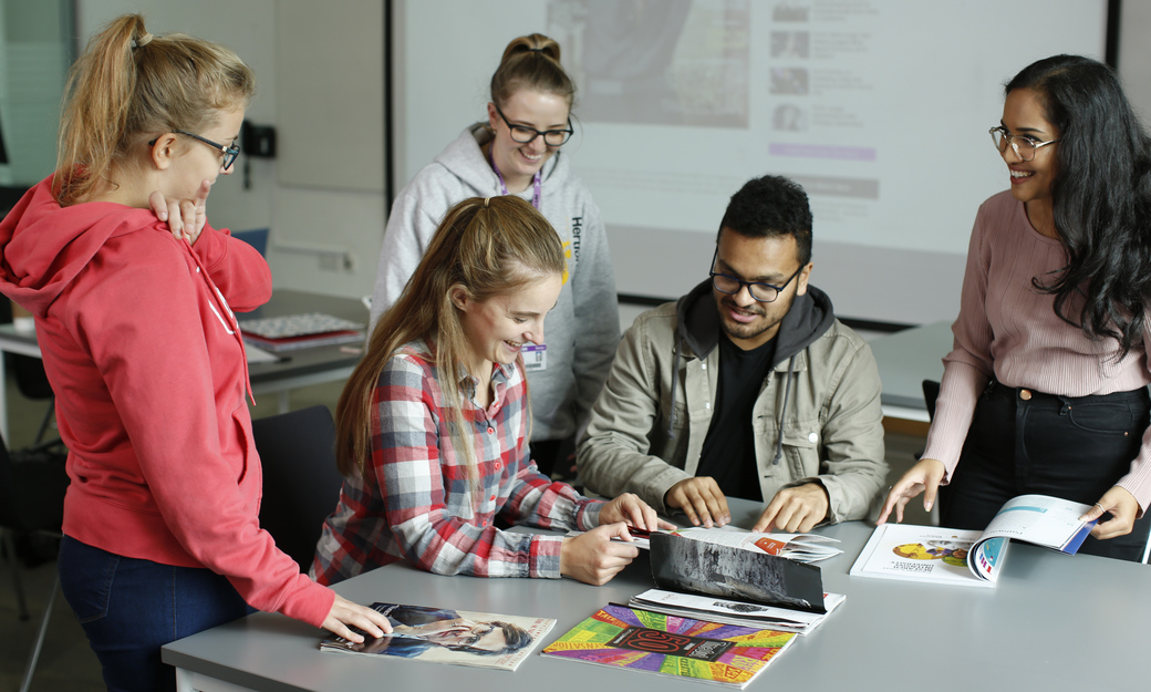 students in class looking through examples of texts 