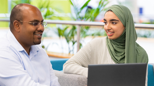 Image of a student with tutor working together on a laptop