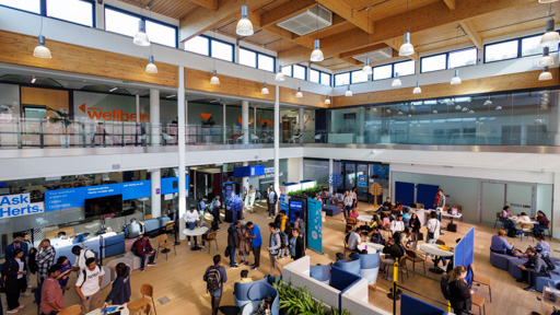 Students on College Lane campus outside the Ask Herts office