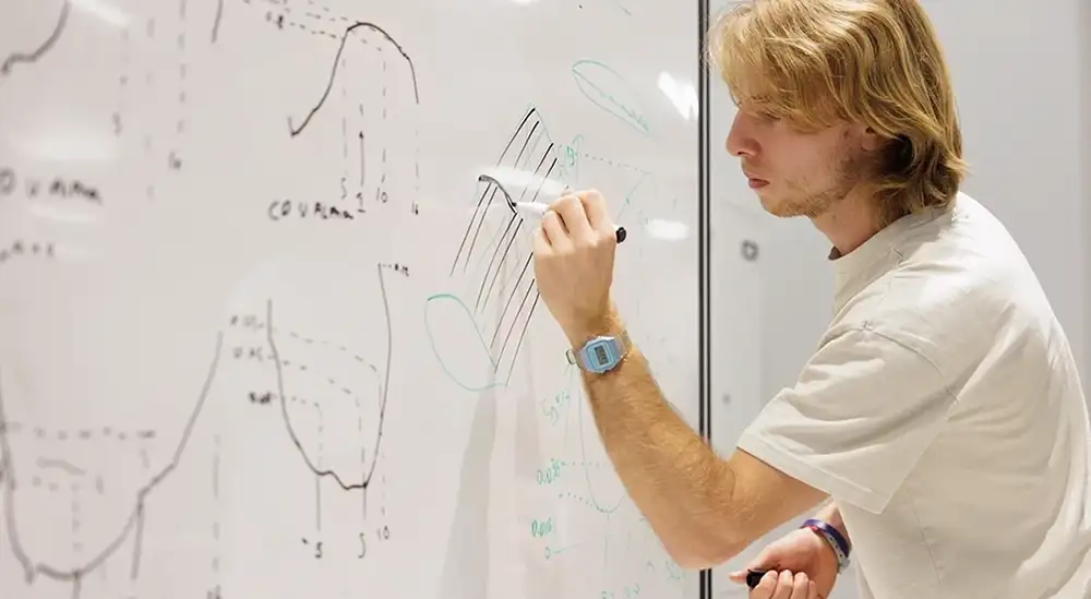 A studnet writing on a white board
