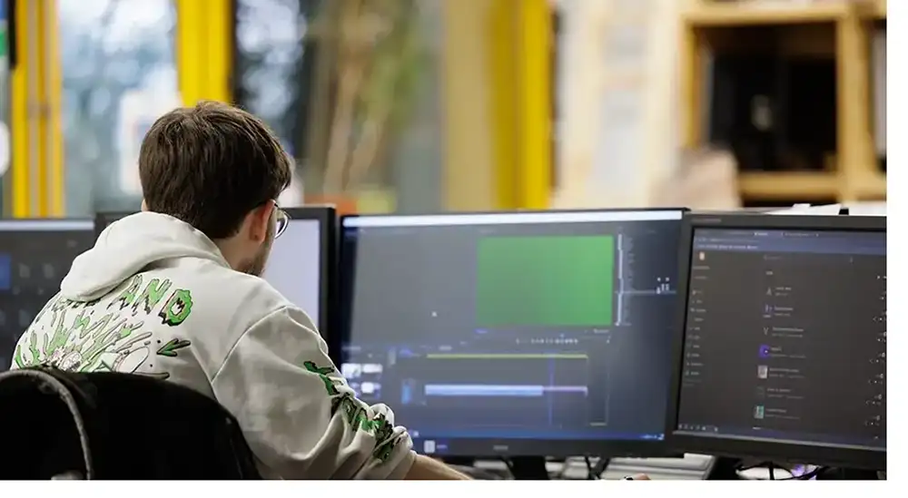 A student working at a computer screen on sound software