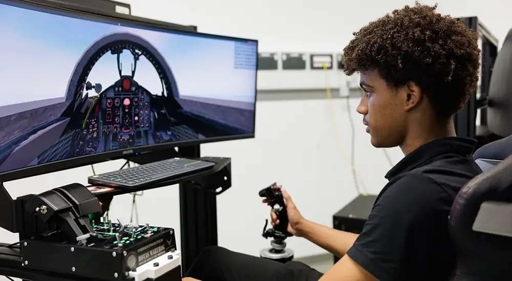 A student using a flight simulator