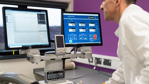 A man looking at several computer screens