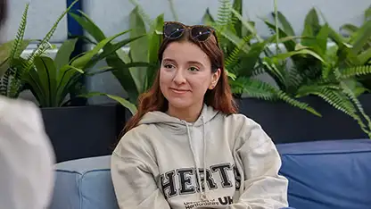 A student sitting on a sofa