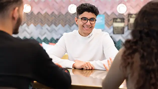 Student smiling talking to others 