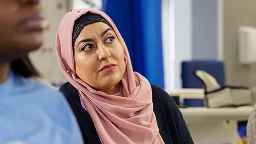 Student in a head scarf listening