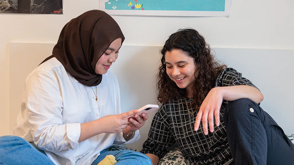 Two people looking at phone