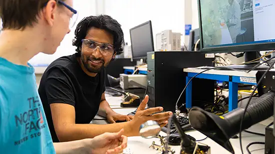 Two students working on electronics