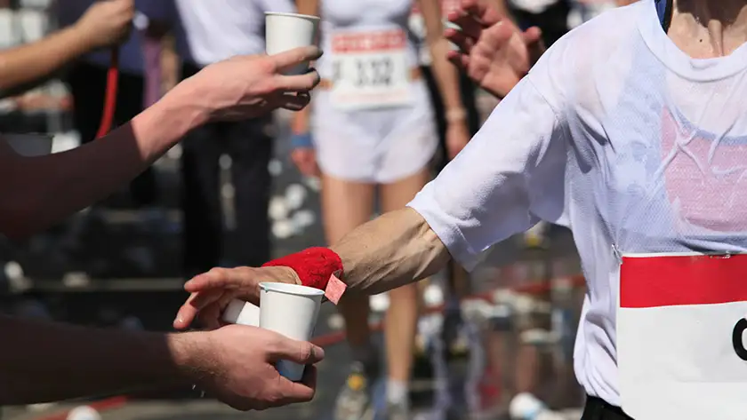 A person grabbing water at an event