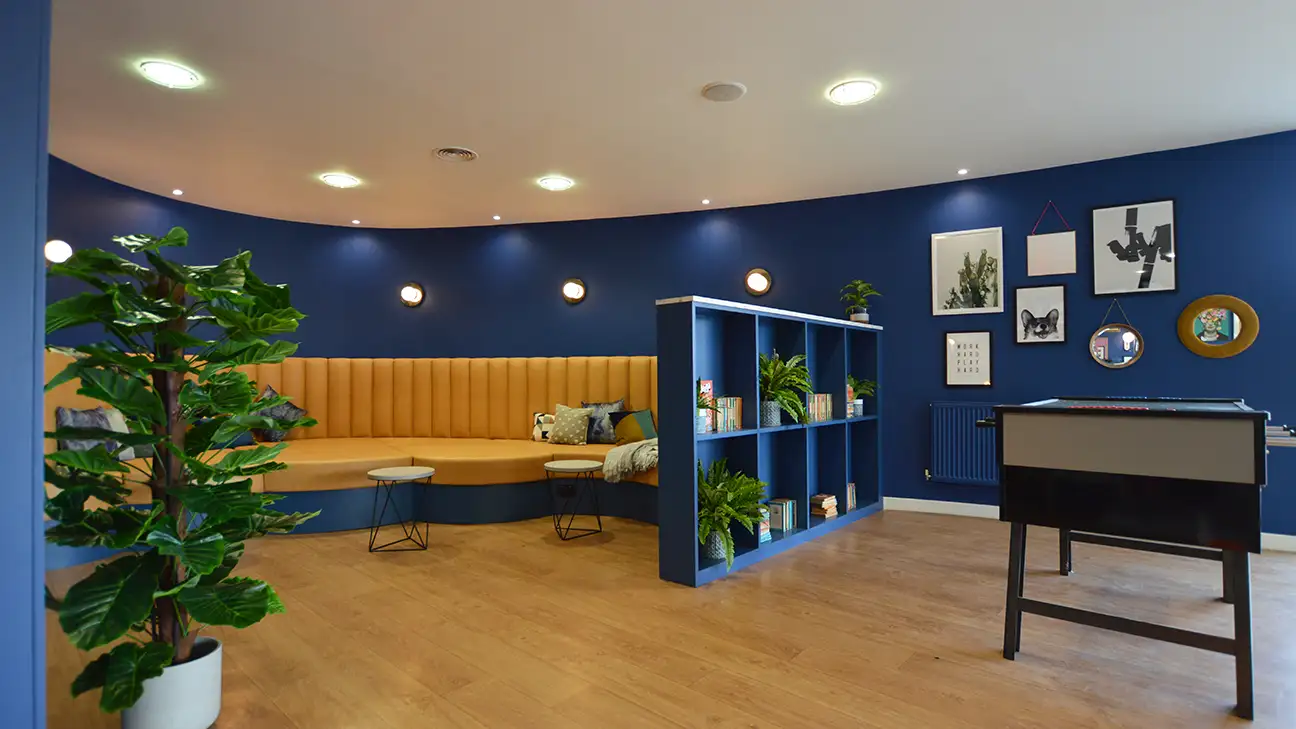 Round sofa with blue walls