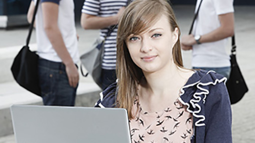 Student outside on laptop