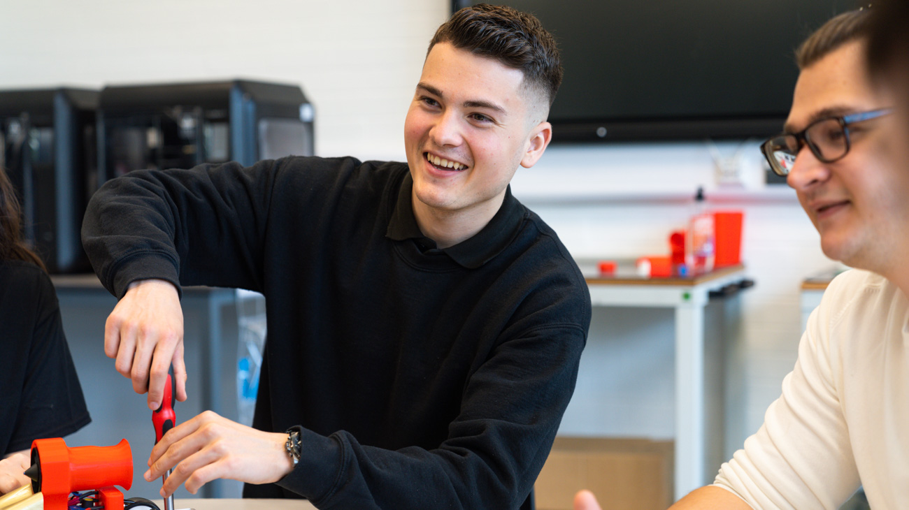 a good example of a member of the herts community looking straight at the camera in a well lit university location