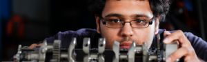 a student works on an engine