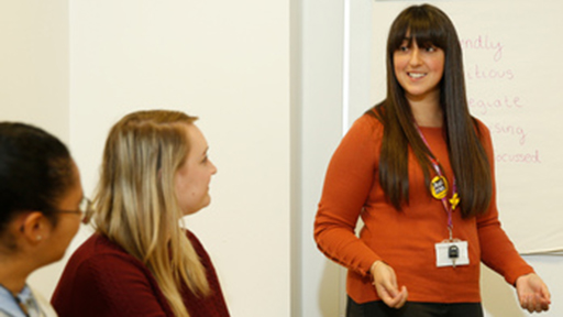 a woman presenting in a business meeting