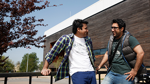 Two male students chat outside