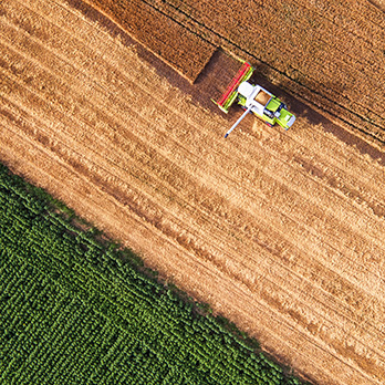 An overhead shot of a tractor harvesting a field
