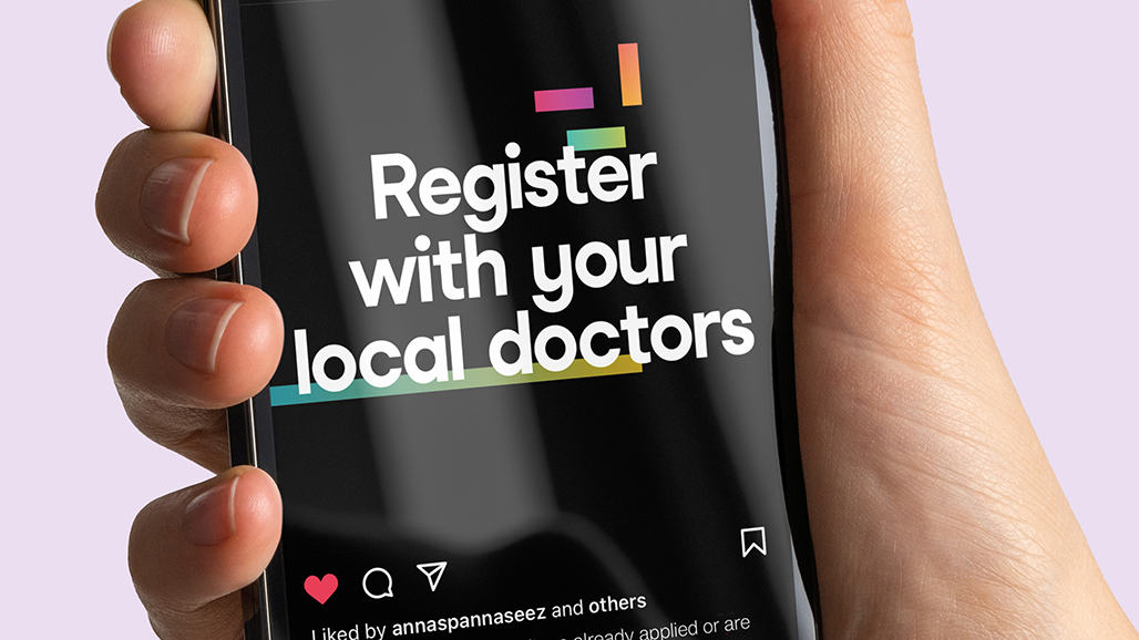 hand holding an iPhone, displaying a social media post by the university of hertfordshire