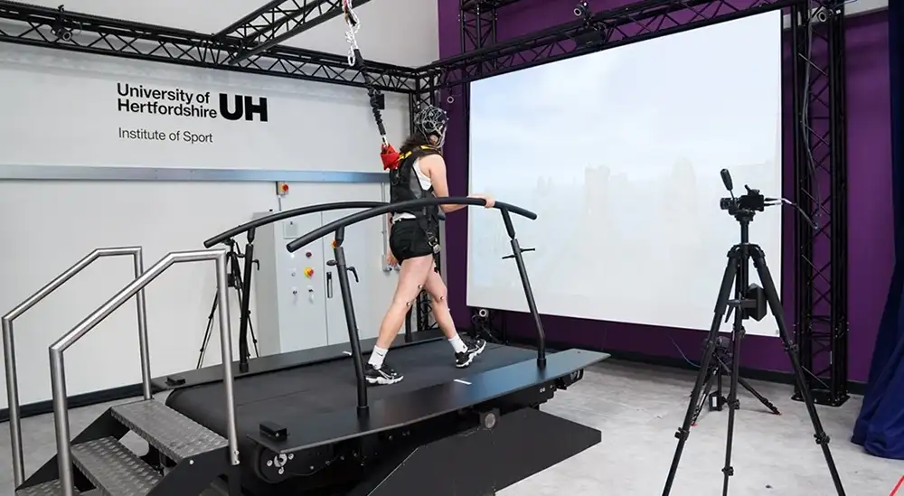 A close up of a aperson on a treadmill with wires
