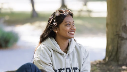 student smiling outside