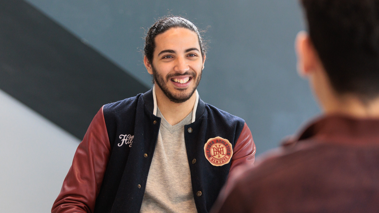 a good example of a member of the herts community looking straight at the camera in a well lit university location
