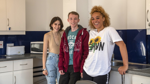 Female and male students in student kitchen