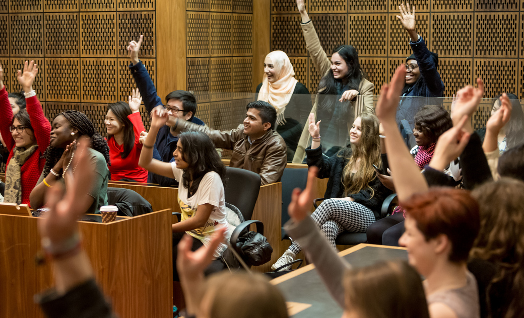students raising their hands in a mock court case 