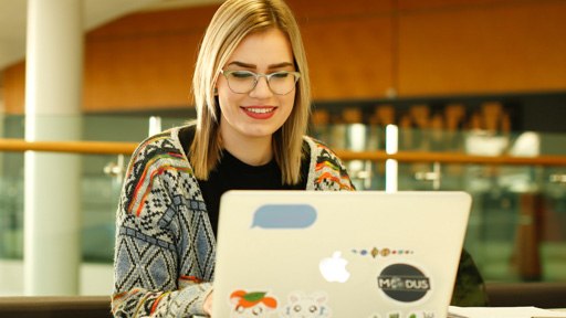 Image of a female working on a laptop