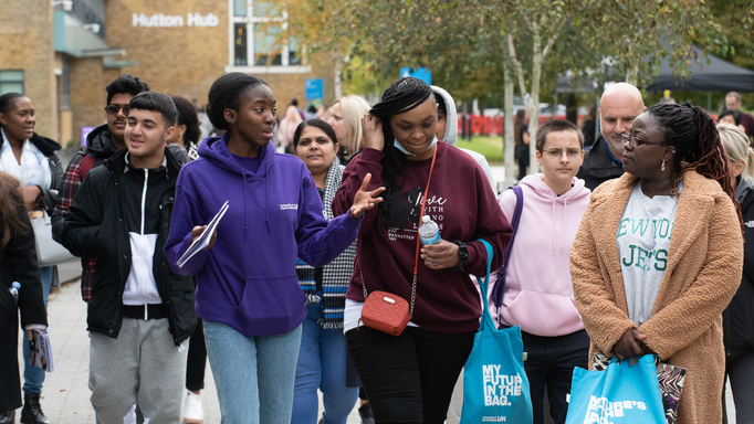 Image of a group of young people on a tour of the Herts campus