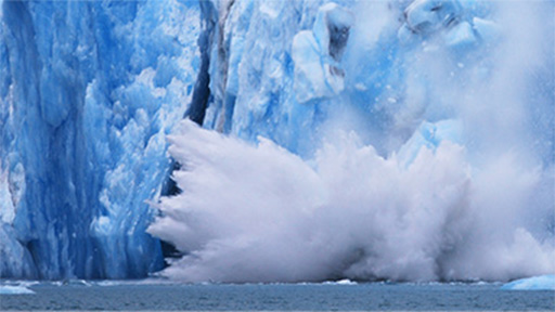 Iceberg melting and a piece falling into the ocean