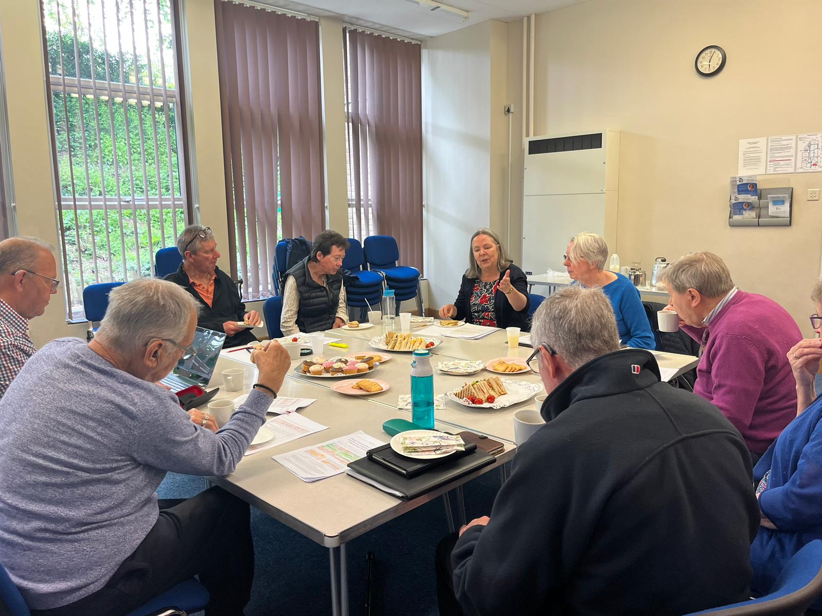 People round a table talking