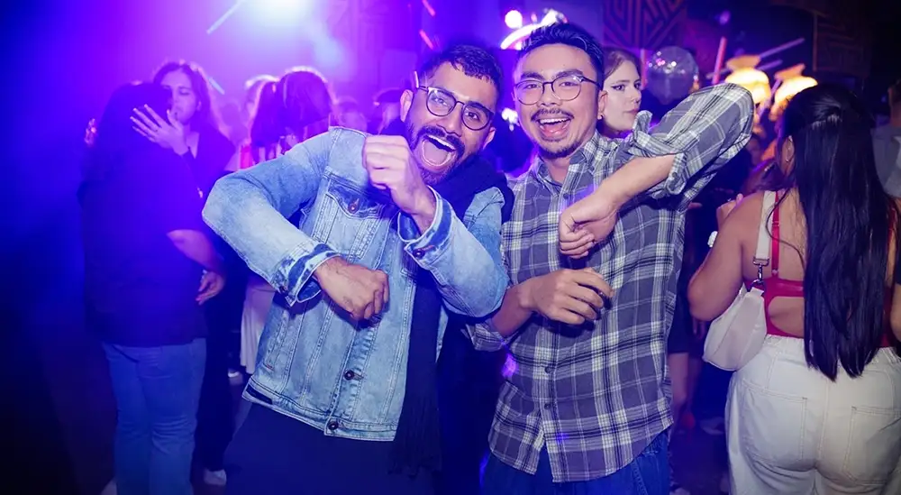 Two students posing for a picture in the University nightclub