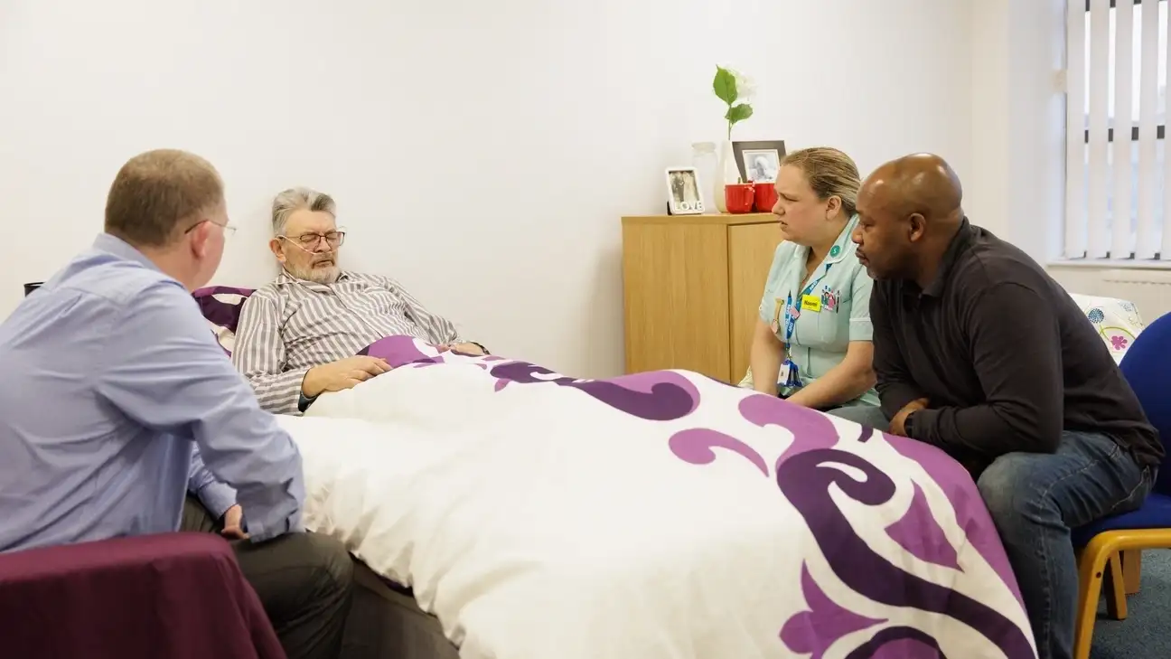 A student practicing bedside manner with a patent in bed