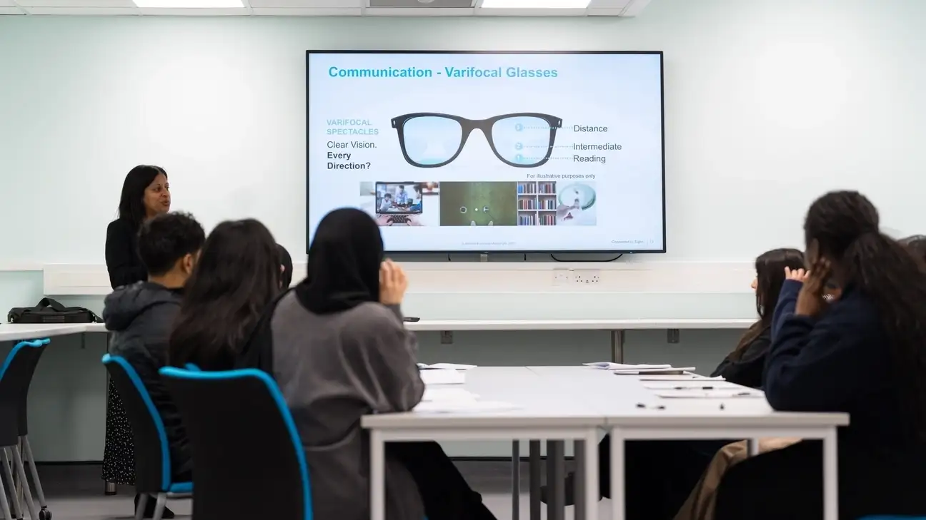 A group of students looking at a screen with glasses on it