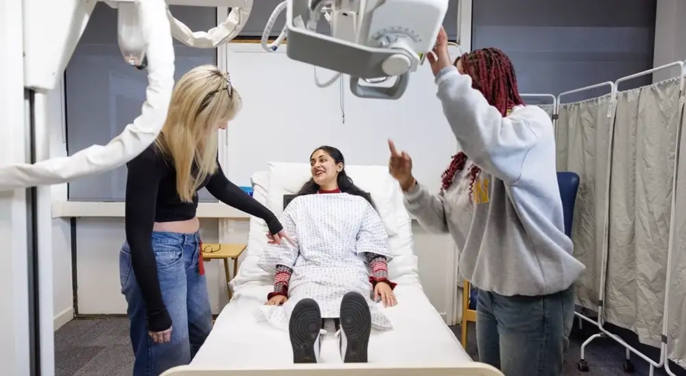 Two students practicing  with an x-ray machine
