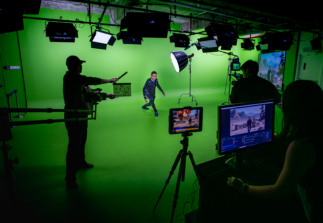 Someone walking in front of a green screen in a studio