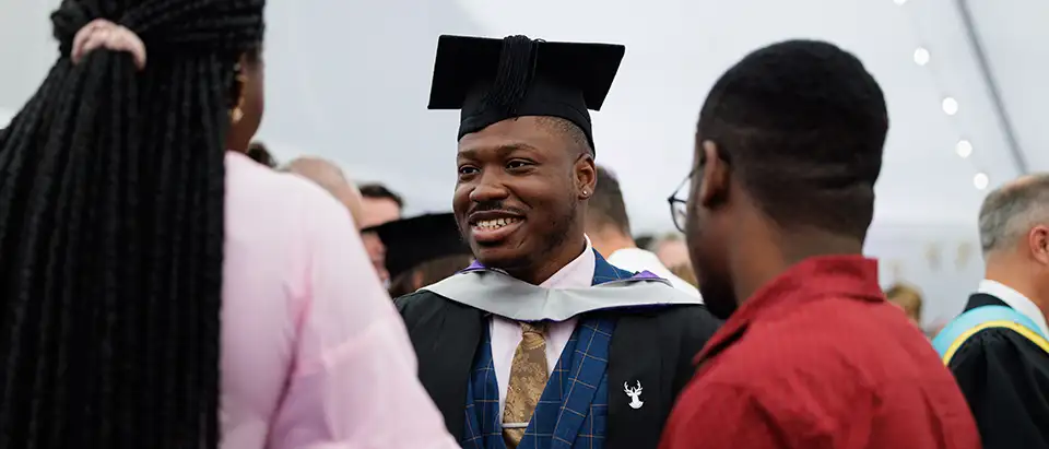 Student smiling talking to others 