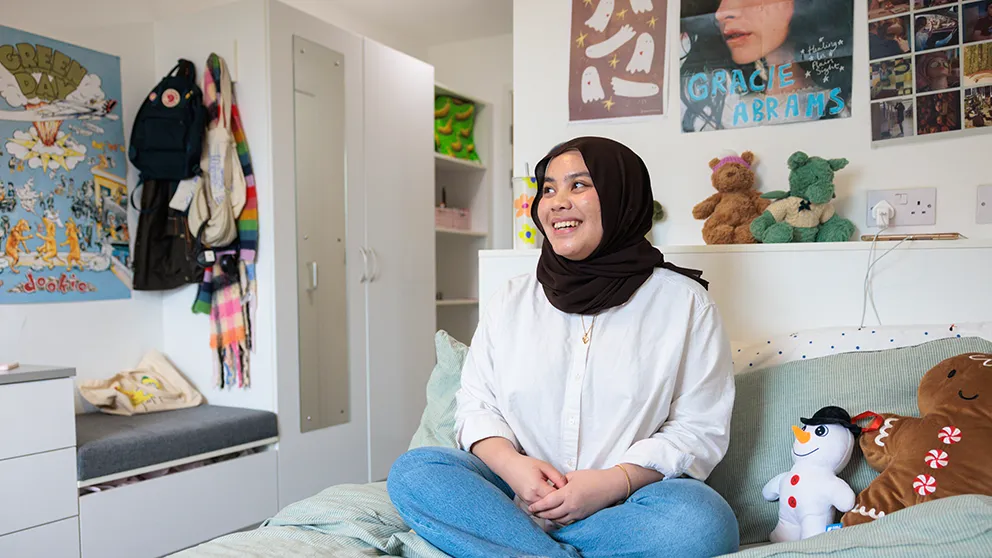 Person sitting on a bed 