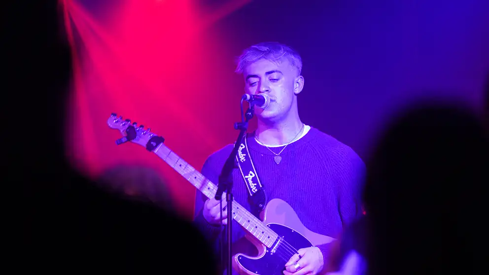 Person playing guitar header