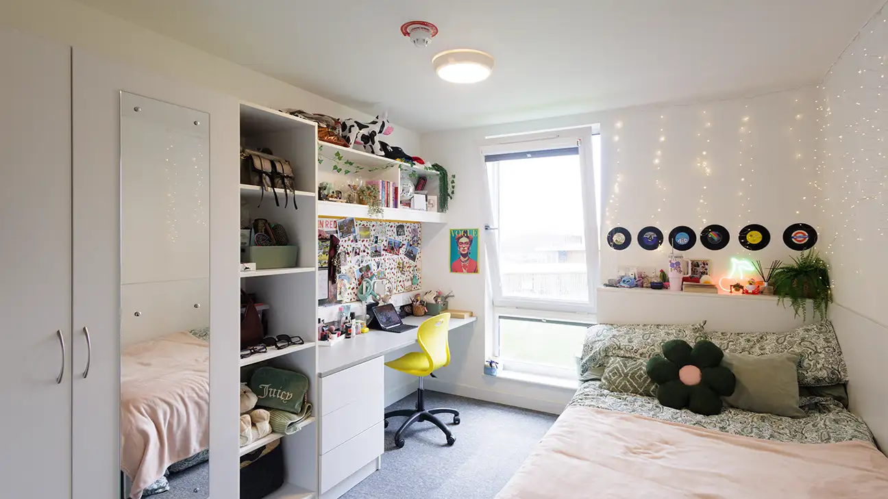 Waredrobe, bed and desk with laptop