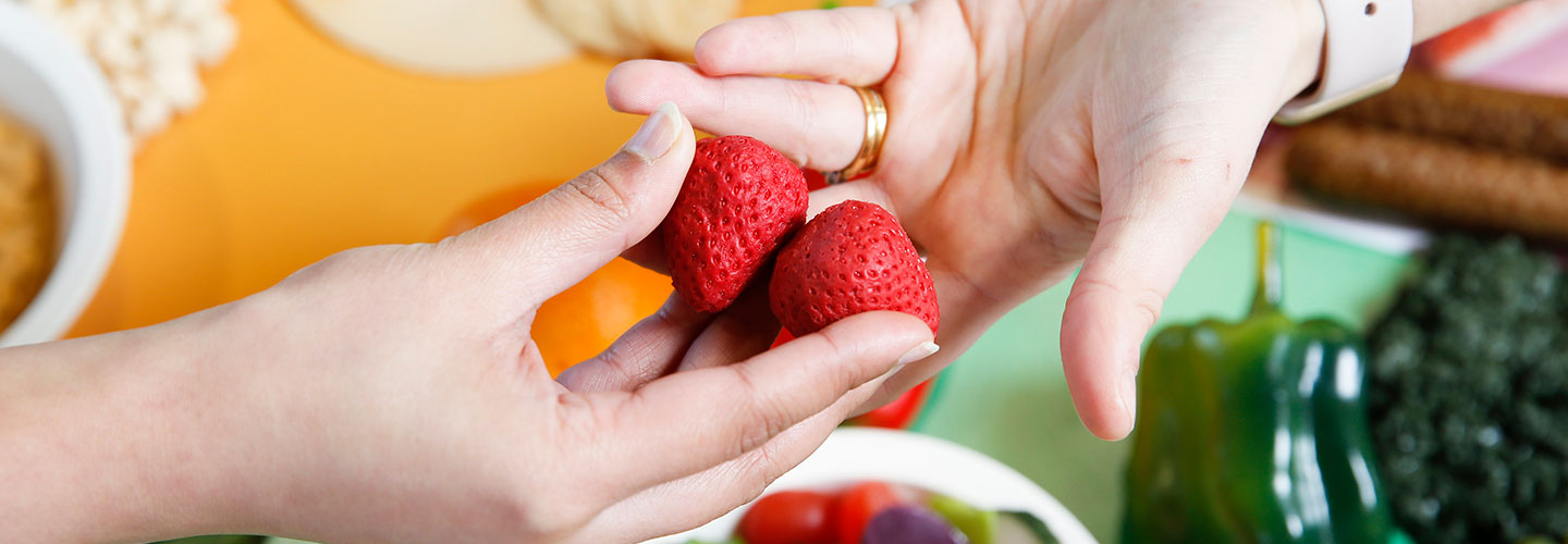 Strawberries held in hands