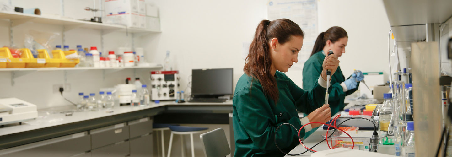 Two female biochemistry students working in a lab