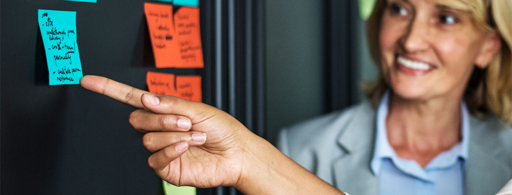 Women pointing at post it notes