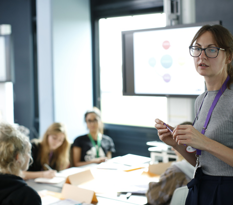 Female academic teaching students in classroom