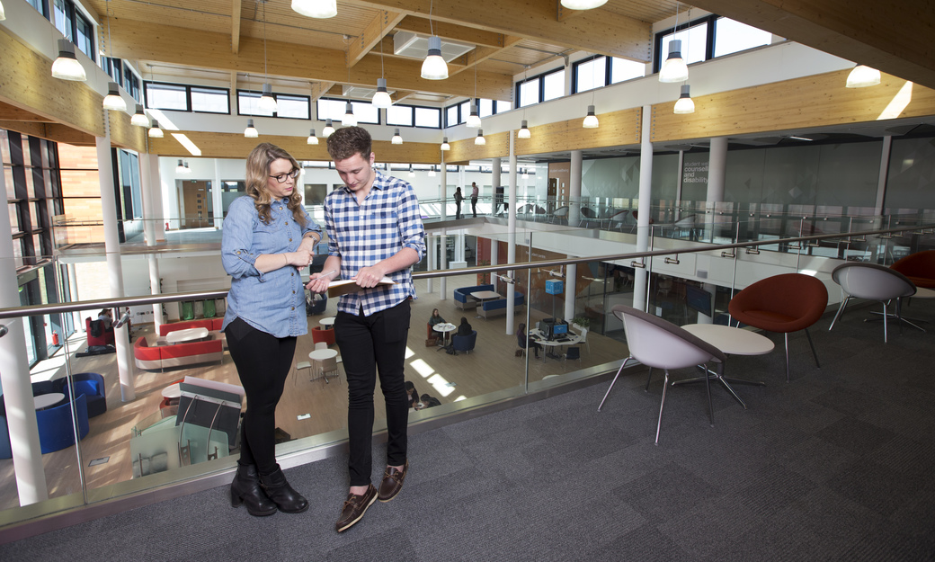 Male and female student talking in Hutton Hub