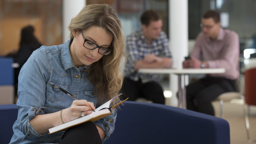 Female student studying in social space
